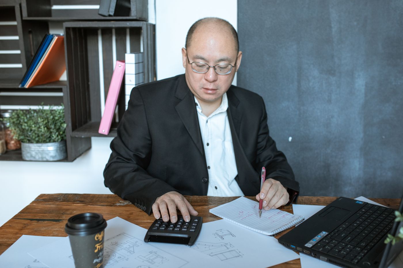 A finance officer working with papers and a calculator
