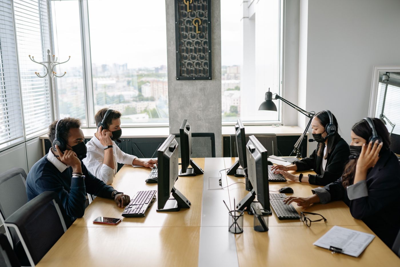 Members of the team on calls at their desks